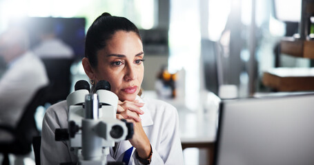 Computer, scientist and thinking with woman with microscope for healthcare, medical research or...
