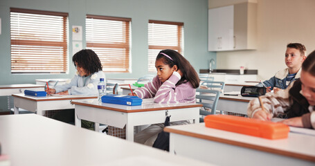 Classroom, students and exam for education, school and learning for assignment in junior grade. Quiz, growth and children with knowledge test, scholarship and development to prepare in academy