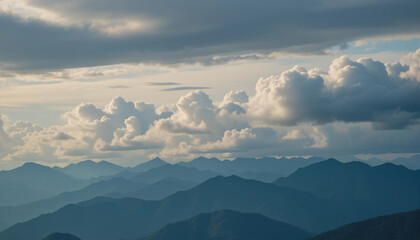 Mountain Range Under Cloudy Sky: A breathtaking panorama of a majestic mountain range stretches across the horizon, partially veiled by a dramatic sky filled with fluffy cumulus clouds.