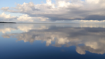 Fototapeta premium Clouds and reflections early morning waterscape