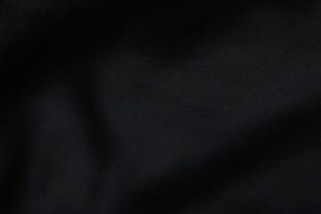 Fototapeta premium Abstract Fabric Texture: A close-up shot of dark fabric with subtle folds and shadows, creating a rich, textured aesthetic. 