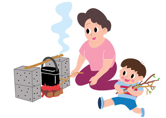 キャンプでハンゴウ炊飯するお母さんと男の子
