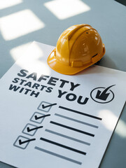 Workplace safety message: A yellow construction helmet rests on a sign highlighting a commitment to workplace safety, Workplace safety, Workplace safety poster