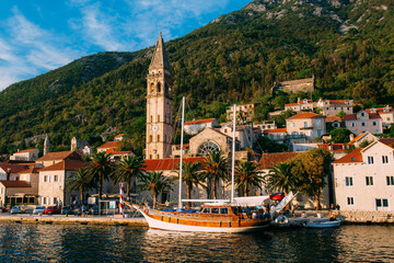 Charming Coastal Town with Historic Architecture and Sailboat