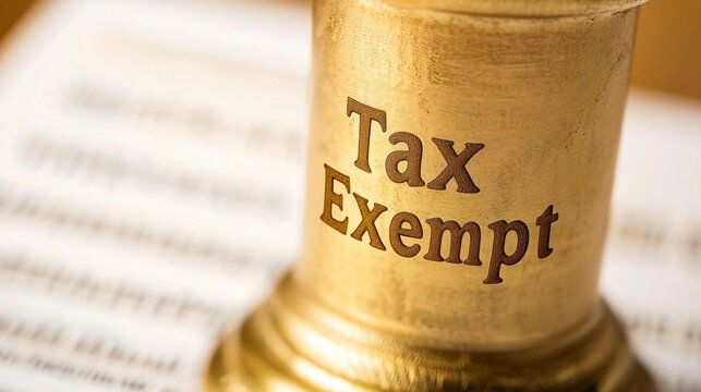 Golden tax exempt stamp pressed on official document with copy space, financial approval concept, government tax relief policy and legal exemption certification for business.