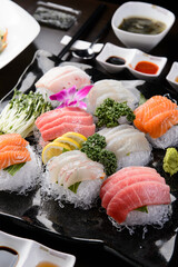 Sashimi decorated with flowers and grass

