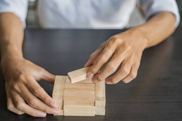 Planning risk and strategy in businessman gambling placing wooden block.Business concept for growth success process.