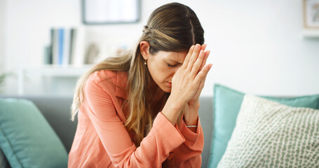 Praying, sad and woman with stress, home and emotional for financial crisis in lounge and thinking....