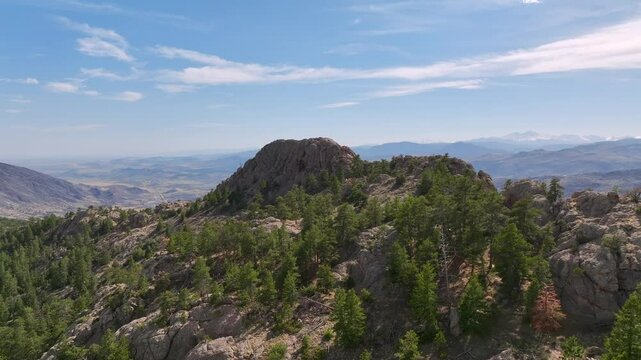 Horsetooth Mountain, Colorado drone footage - Aerial view of the summit of Horsetooth Mountain flying low over the pine tree tops in Larimer County, CO.