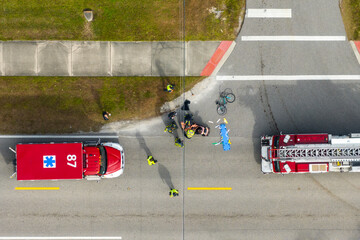 Car crash with first responders helping cyclist on a stretcher who was hit by car at accident site...