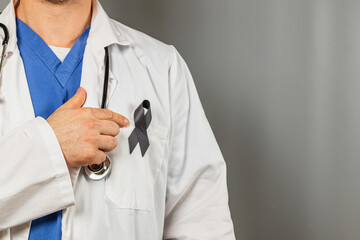 Health professional showing support with a black ribbon on uniform