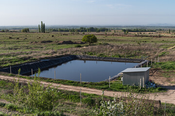 Artificial storage pond for watering agricultural crops.