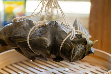 Zongzi, bamboo leaves, steamer, glutinous rice, wrap, rope, traditional, asian, food, cuisine, dragon boat festival, festival, close-up, uncooked, prepared, wood, basket, multiple, tied, thread, steam