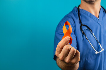 Healthcare pro promotes awareness with an orange ribbon on blue