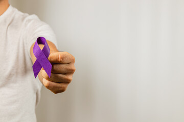 Support for a cause with a purple ribbon in hand