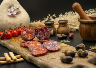 Delicious Assorted Salami Arranged with Fresh Ingredients Served on a Wooden Board