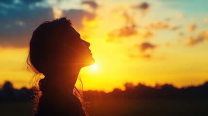 Silhouette of a serene woman gazing towards a stunningly vibrant sunset while immersed in peaceful contemplation and deep thoughtfulness outdoors