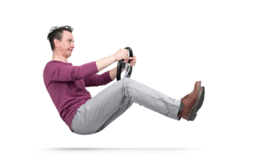 Man simulating driving pose, suspended in air, holding a steering wheel. PNG with transparent background. Creative concept of movement, humor, control, speed, imagination.