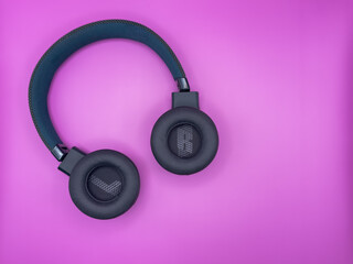 Green headphones with soft inverted earbuds with the letters L and R and a soft headband are lying...