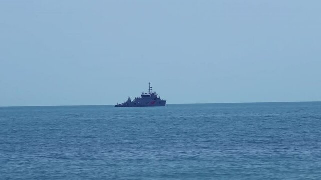Stunning 4K footage of a coast guard ship patrolling the serene ocean, perfect for maritime themes, security visuals, and travel projects.