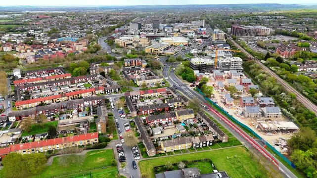 Aerial view of Basildon a densely populated town with houses, a roundabout and green spaces