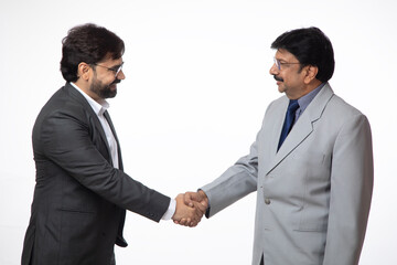 Indian two business men shaking hands together on white background