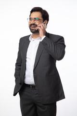 Indian happy business corporate man taking  on mobile phone on white background. Concept of digital and business technology