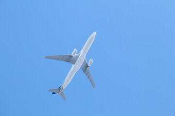 Passenger airplane isolated in blue sky. Aviation idea concept. Aircraft climbing. Abroad travel. Air transportation. Copy space, blank, empty.