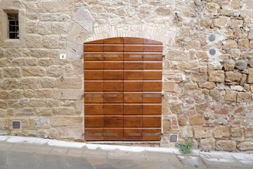 Exterior architecture and wooden door design of of rocky stone and red brick wall