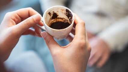 A fortune told by inspecting the grounds remaining in one's coffee cup