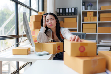 Young stressed small business owner woman is having a headache while managing her online store and...