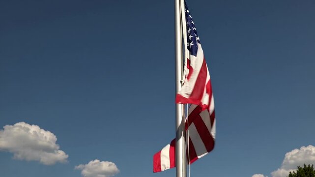 American Flag weaving proudly blue sky viwe