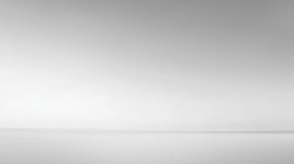 Minimalist landscape of tranquil water under a soft gray horizon at dawn capturing serene beauty