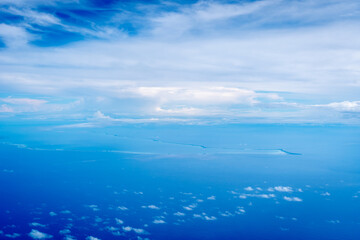 Aerial view of the Tuamotus atoll in French Polynesia with clouds