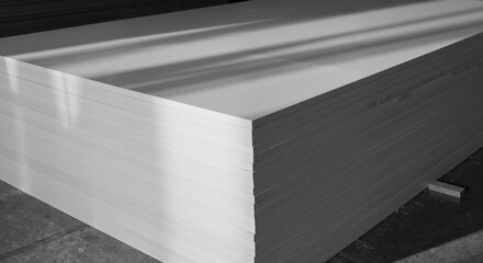Obraz premium White industrial sheets stacked in a warehouse environment 