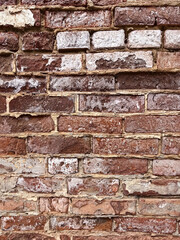 textured wall of red old brick with weathered surface
