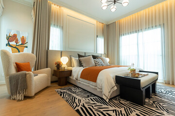 Modern cobalt blue bedroom with double bed with carpet and window.