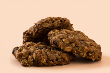 Homemade oatmeal cookies. Side view of a stacked oatmeal cookie on a beige background . Bakery. Vegetarian food. Healthy breakfast .
