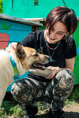 Dog in the shelter. Animal shelter volunteer takes care of dogs.