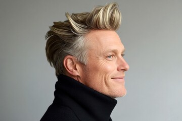 Obraz premium Pure white solid background. A masculine beauty with a relaxed and happy expression. Idea of style for aging men. Elegant men's quiff haircut - midlife white man with blond hair.