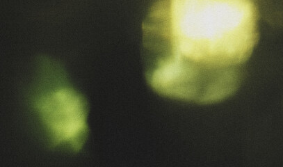 A soft green light shines on a dark textured background.