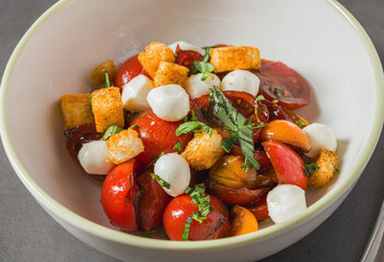 Top view of Italian Panzanella salad on grey stone table