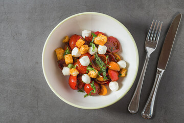 Top view of Italian Panzanella salad on grey stone table