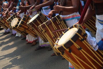 Chenda is a traditional percussion instrument originating from Kerala, India, used in temple rituals, classical dance forms like Kathakali, and other cultural festivities. It's a cylindrical drum