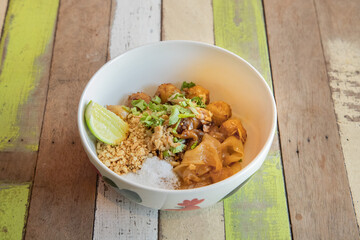 Delicious pad thai dish restaurant food photography cozy atmosphere close-up thai cuisine