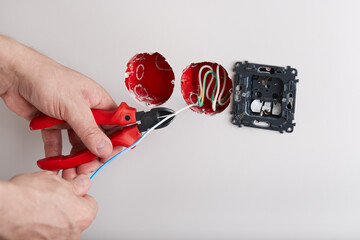 An engineer is installing new sockets during the renovation. 