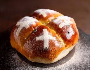 Fototapeta premium A close-up of a hot cross bun dusted with flour, representing a traditional baked good associated with the Easter season.