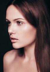 Fototapeta premium Fashion beauty portrait of young brunette woman with natural makeup and perfect clean skin. Pure model with posing in studio