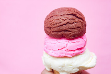 close up of stack of ice cream cones on pink background