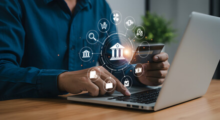 Person Holding Credit Card and Using Laptop With Online Banking Icons Overlay in Bright Ambient Light